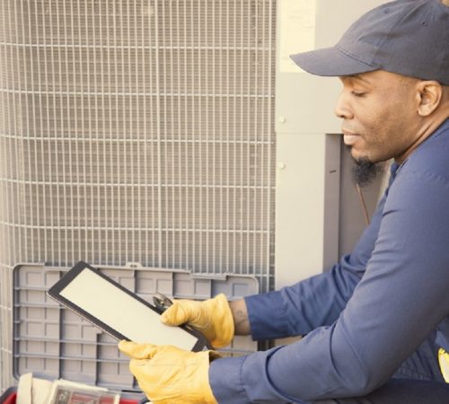 black-HVAC-tehcnician-reading-ipad